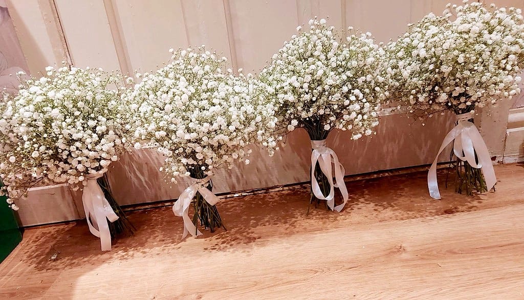 Four cloud-like gypsophila bridal bouquets, each finished with satin ribbon